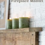 3 green pillar candles in DIY rustic wood mantel